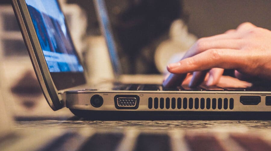 person typing on laptop