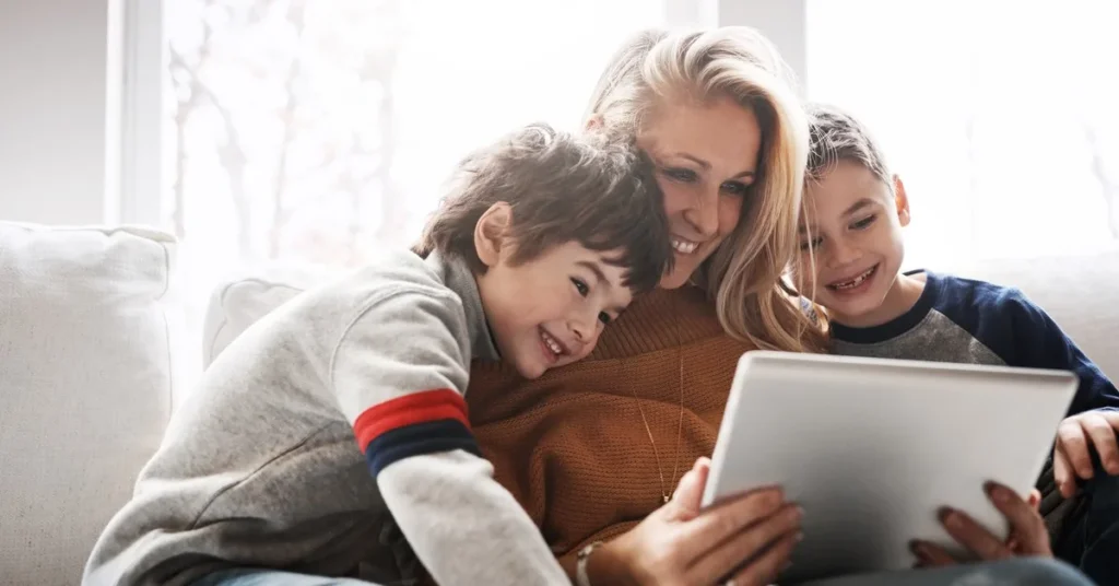 Mother and children using a tablet at home connected to broadband internet