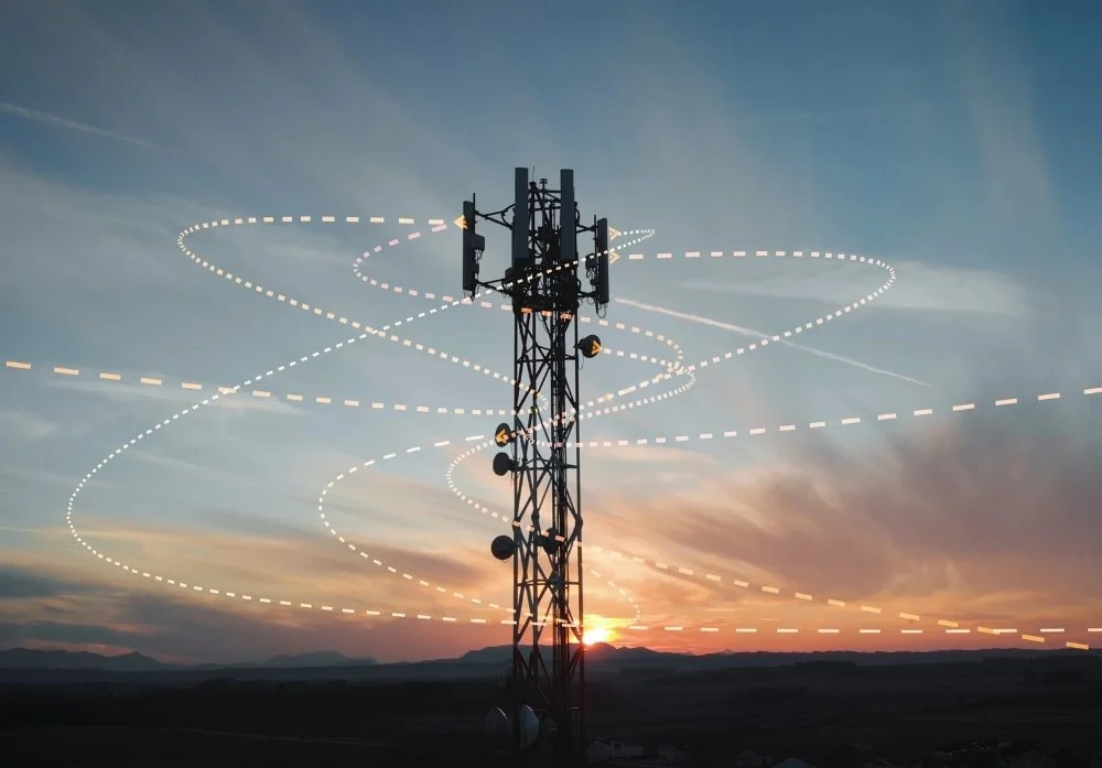 Sunset view of tower with overlay of signal waves