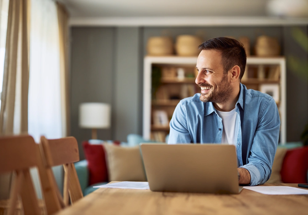 Man working from home while looking out window